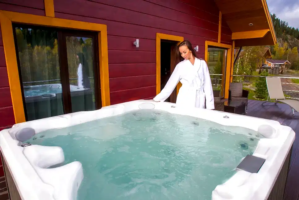 A woman about to enter a well maintained hot tub